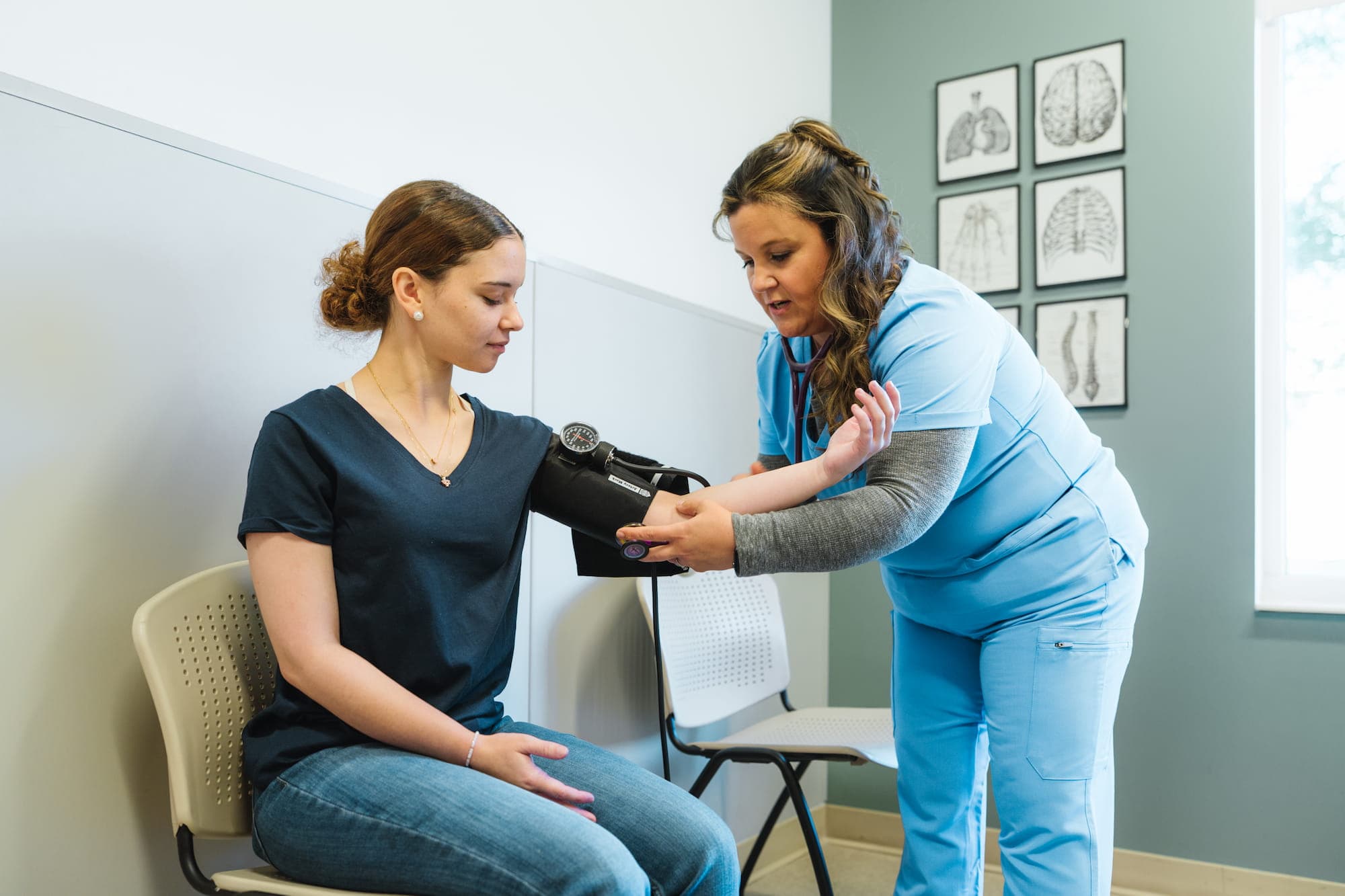 A patient having her blood pressure checked by a clinician