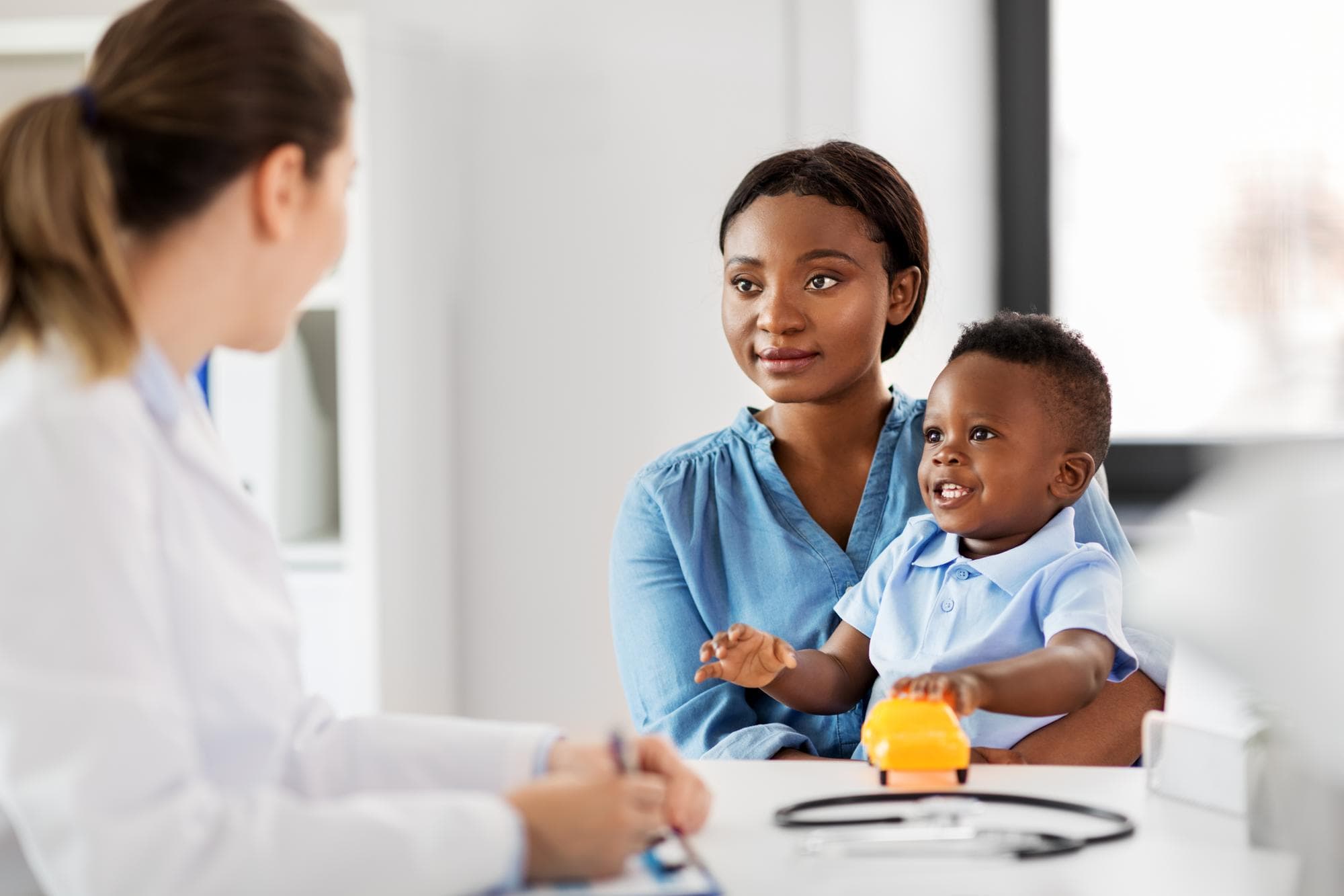 A mother and child smiling during a primary care visit